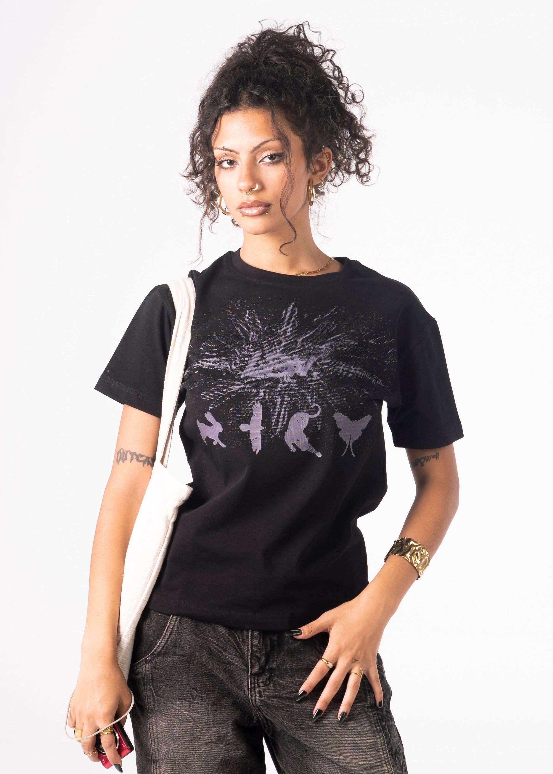 Woman wearing a black t-shirt with a graphic design on a white background
