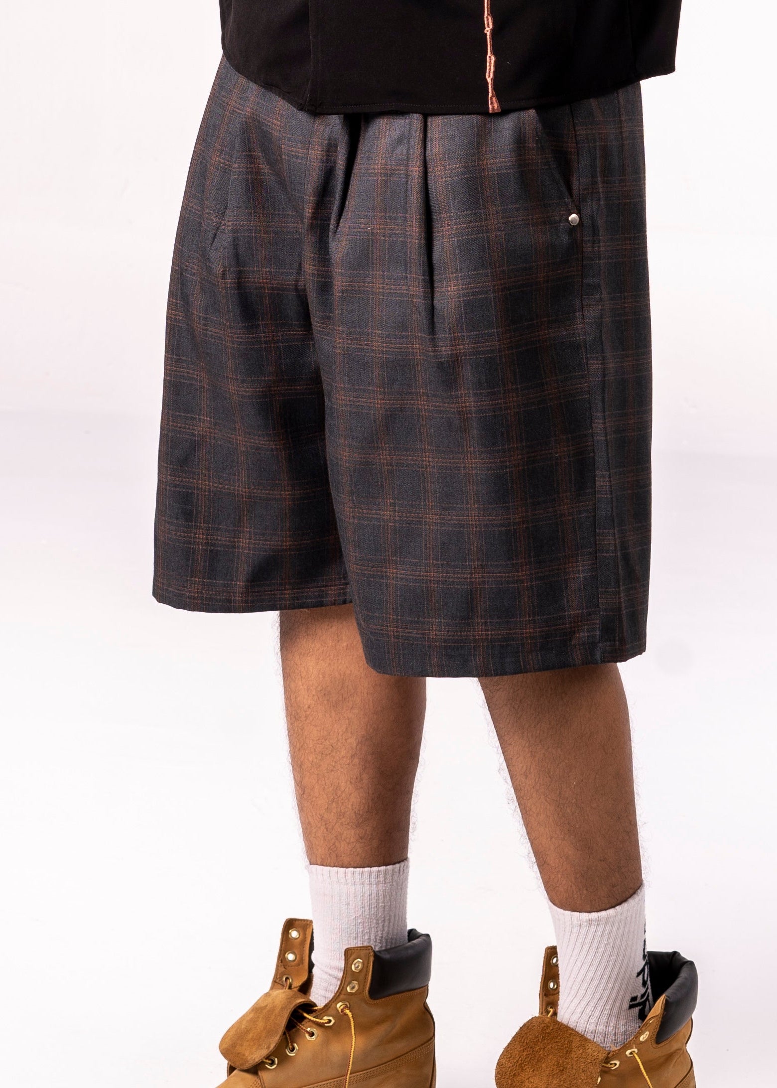 Plaid shorts worn by a person on a white background