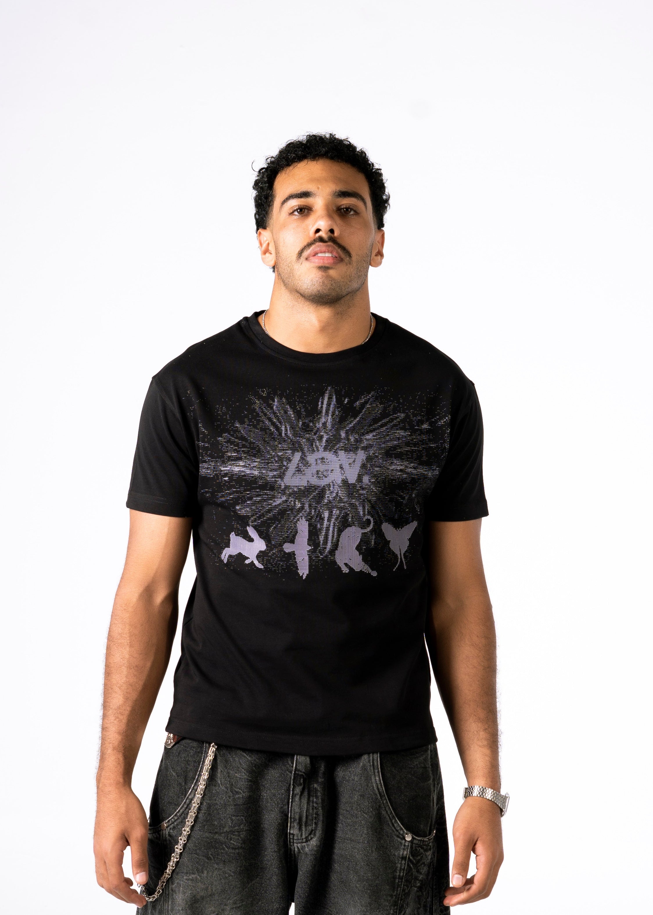 Man wearing a black t-shirt with a graphic design on a white background